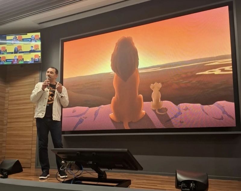 Tela com Mufasa e Simba observando o horizonte, projetada durante a palestra